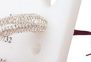 Knit wire being drawn through a drawplate